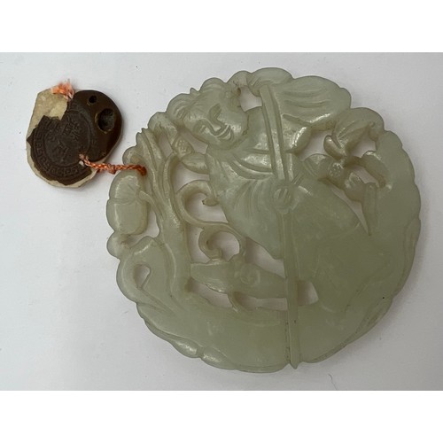 970 - A Chinese carved jade pendant with wax seal 5.5cm d.