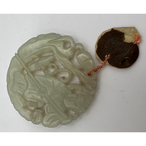 970 - A Chinese carved jade pendant with wax seal 5.5cm d.