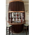 A vintage mahogany and copper barrel shaped bar. 240cm h x 90cm d x 171cm w. Spirits and glassware n... 