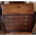 A Georgian mahogany bureau of four graduated drawers with original handles on bracket feet. 101cm w ... 