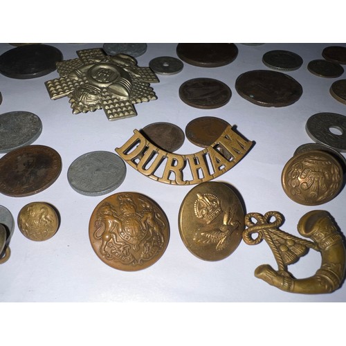 558 - Coins and military badges to include Durham badge, Francs etc.