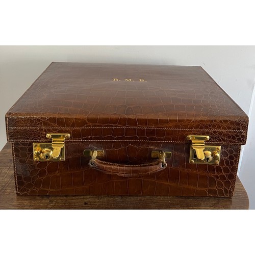 975 - A superb quality early 20thC crocodile fully fitted travelling dressing case. This comes with the or... 