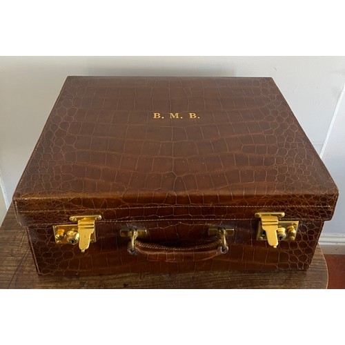 975 - A superb quality early 20thC crocodile fully fitted travelling dressing case. This comes with the or... 