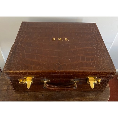 975 - A superb quality early 20thC crocodile fully fitted travelling dressing case. This comes with the or... 