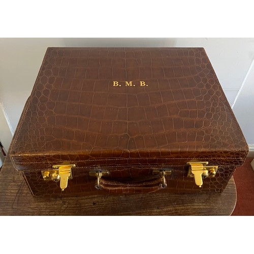 975 - A superb quality early 20thC crocodile fully fitted travelling dressing case. This comes with the or... 