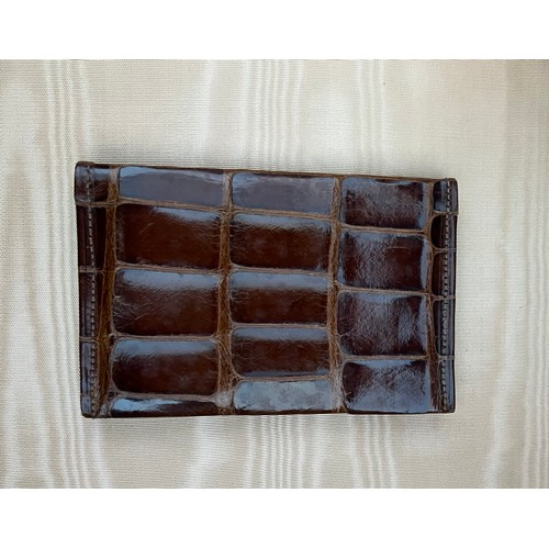 975 - A superb quality early 20thC crocodile fully fitted travelling dressing case. This comes with the or... 