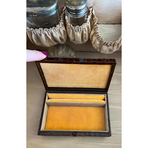 975 - A superb quality early 20thC crocodile fully fitted travelling dressing case. This comes with the or... 