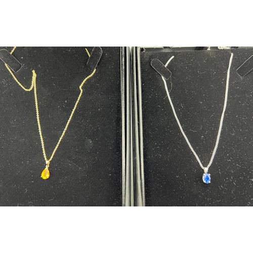 468 - Two 9 carat gold pendant and chains, one in white gold with blue stone, the other yellow gold with y... 