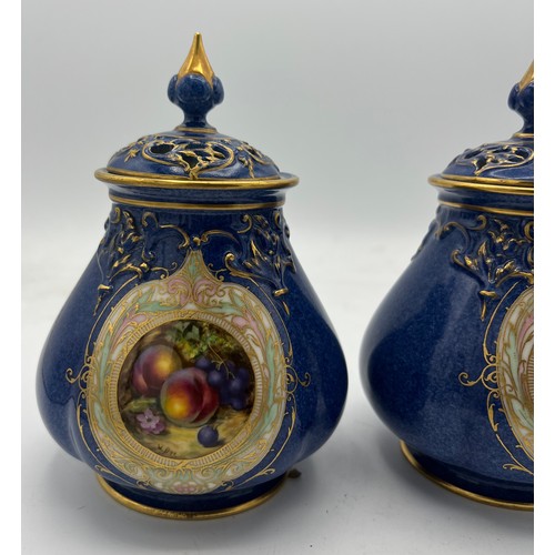 162 - A pair of Royal Worcester pot pourri jars and covers by W. Bee with date mark for 1923. 16cm high.