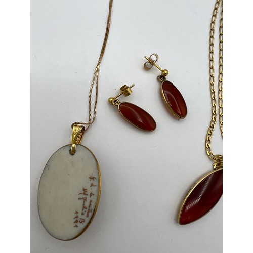 482 - Pendant and matching earrings on 9 carat gold chain together with a hand painted ceramic pendant on ... 