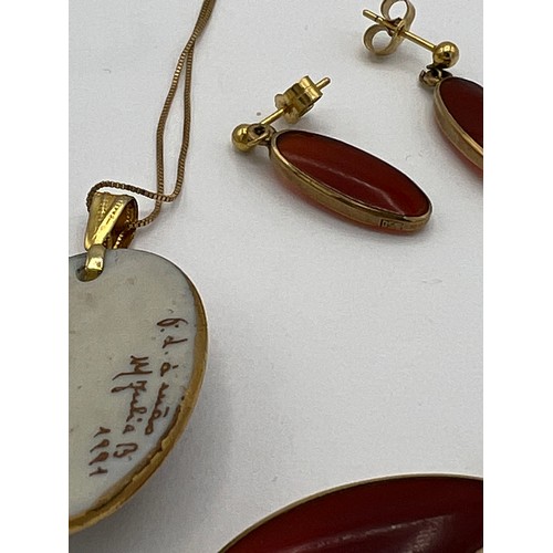 482 - Pendant and matching earrings on 9 carat gold chain together with a hand painted ceramic pendant on ... 