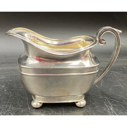 780 - A silver jug on bun feet hallmarked Sheffield 1904 Harrison Brothers & Howson. Total weight 167gms 9... 