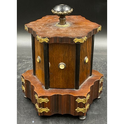 973 - A musical box/sewing companion, hexagonally shaped with ebonised, gilt and shell embellishments on r... 