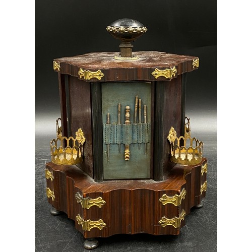 973 - A musical box/sewing companion, hexagonally shaped with ebonised, gilt and shell embellishments on r... 