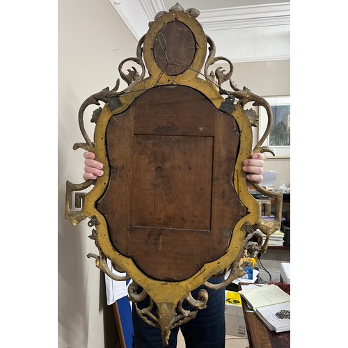 954 - A pair of 18thC ornate carved gilt wood and gesso wall mirrors with two candle sconces. 112cm h x 69... 