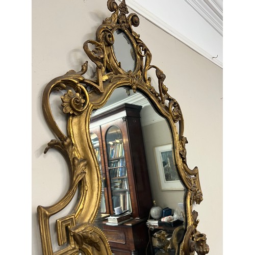 954 - A pair of 18thC ornate carved gilt wood and gesso wall mirrors with two candle sconces. 112cm h x 69... 