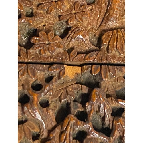 919 - A Chinese sandalwood card case, heavily carved with figures amongst pagodas and foliage, 11.5cm x 7.... 