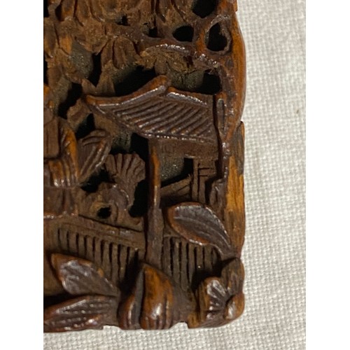 919 - A Chinese sandalwood card case, heavily carved with figures amongst pagodas and foliage, 11.5cm x 7.... 