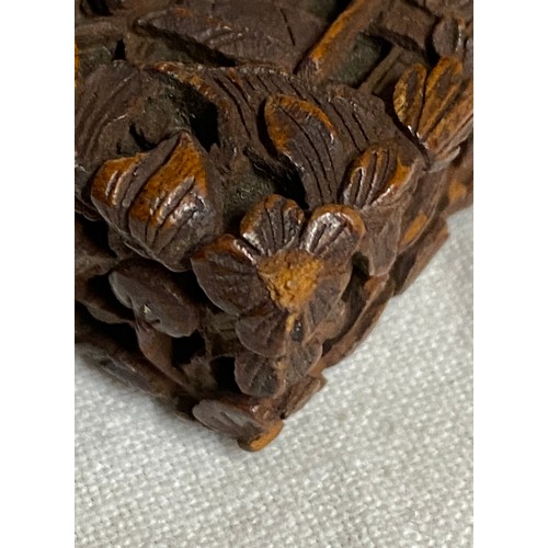 919 - A Chinese sandalwood card case, heavily carved with figures amongst pagodas and foliage, 11.5cm x 7.... 