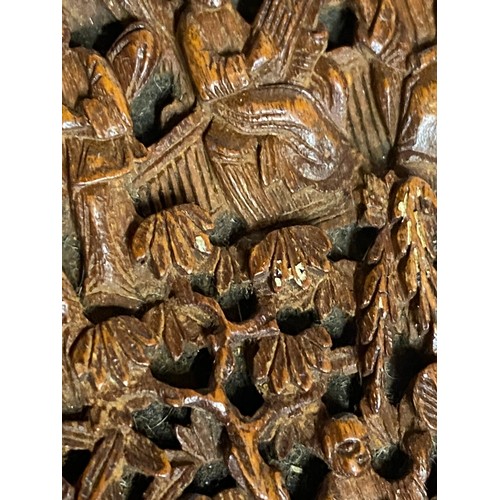 919 - A Chinese sandalwood card case, heavily carved with figures amongst pagodas and foliage, 11.5cm x 7.... 