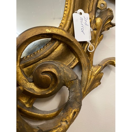 954 - A pair of 18thC ornate carved gilt wood and gesso wall mirrors with two candle sconces. 112cm h x 69... 