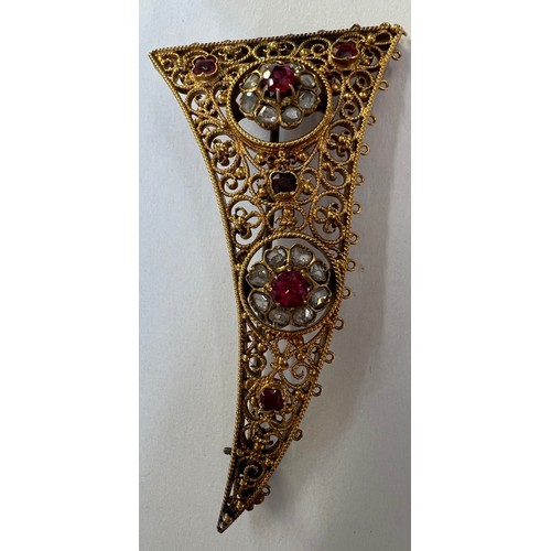 411A - An Indian brooch/pendant, 6cm long, tests as approx. 15ct gold with rubies and rose cut diamonds. We... 