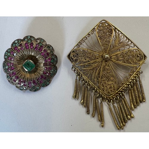 412A - Two brooches to include a white metal round Indian brooch set with rubies, emeralds and clear stones... 