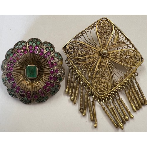 412A - Two brooches to include a white metal round Indian brooch set with rubies, emeralds and clear stones... 