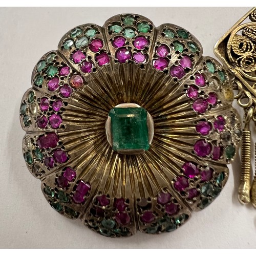 412A - Two brooches to include a white metal round Indian brooch set with rubies, emeralds and clear stones... 