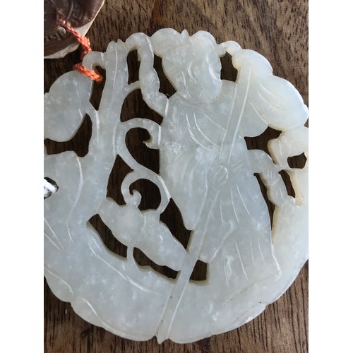 970 - A Chinese carved jade pendant with wax seal 5.5cm d.