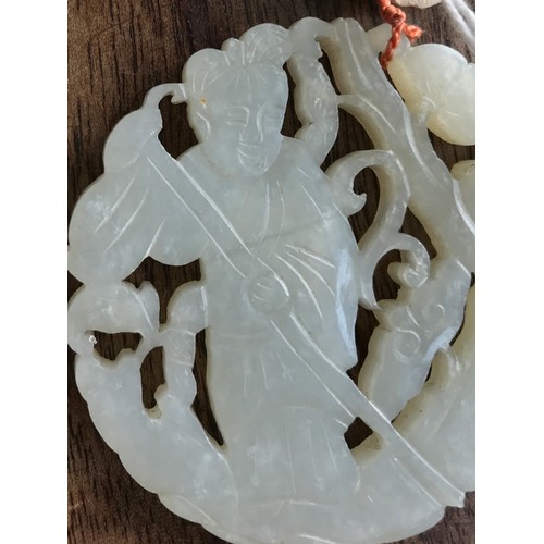 970 - A Chinese carved jade pendant with wax seal 5.5cm d.