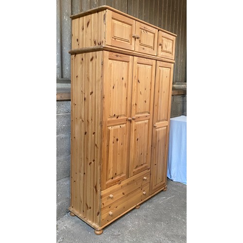 7 - A large pine wardrobe with a combination of three doors over two drawers and a removable 3 cupboard ... 