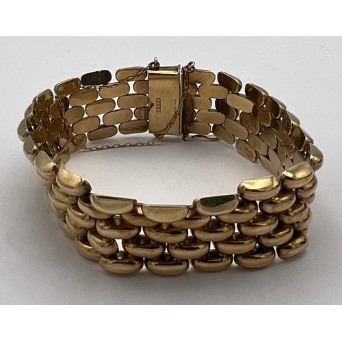 393 - A 9 carat gold bracelet with safety chain. Weight 35.2gm.