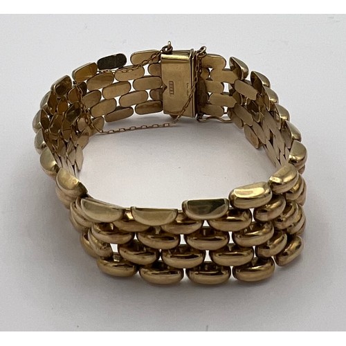 393 - A 9 carat gold bracelet with safety chain. Weight 35.2gm.