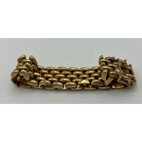 393 - A 9 carat gold bracelet with safety chain. Weight 35.2gm.