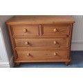 A pine chest of two short over two long drawers. 79cm h x 98 w x 50 d.