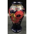 A William Moorcroft Pomegranate patterned vase signed to base 24cm h.