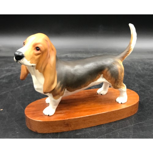 198 - Two Beswick matt pottery figures of dogs one a basset hound, on wooden plinth 15.5h the other a Sett... 