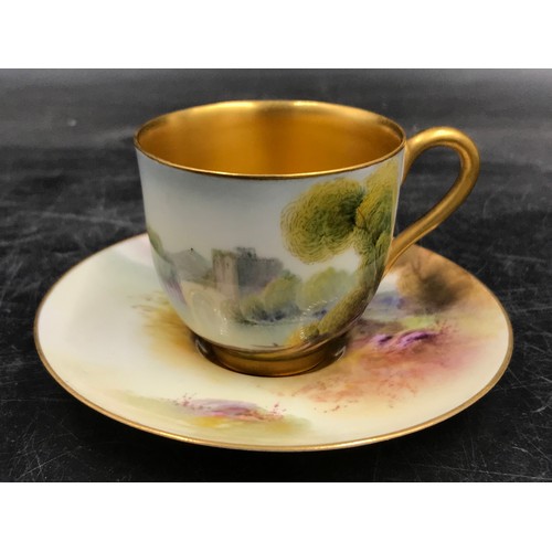 201 - A Royal Worcester Raymond Rushton coffee cup and saucer painted with castles by a river landscapes, ... 