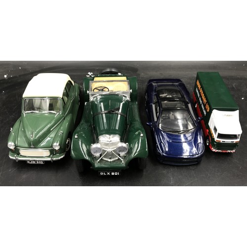 894 - A collection of toy cars to include a Maisto jaguar XJ220 racing on stand, another smaller Maisto ja... 