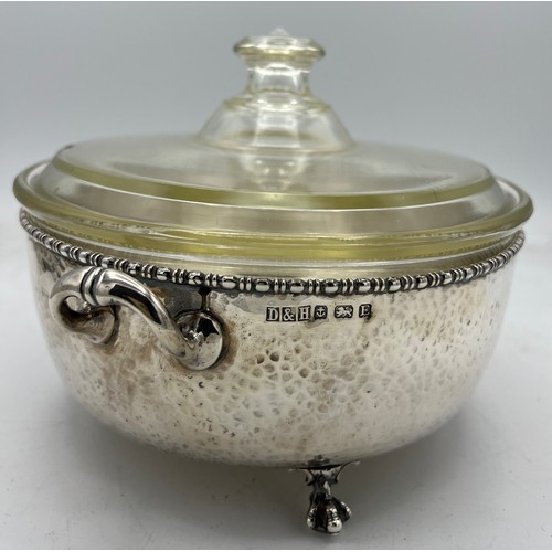 788 - A twin handled hammered silver dish holder raised on paw feet with lidded Pyrex dish. Birmingham 192... 