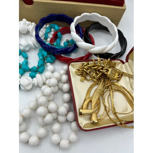 386 - A quantity of vintage costume jewellery to include watches, bead necklaces and bangles etc.