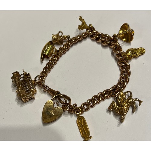 394 - A 9 carat gold bracelet with eight charms of 9, 14 and 18 carat. Total weight 47gm.