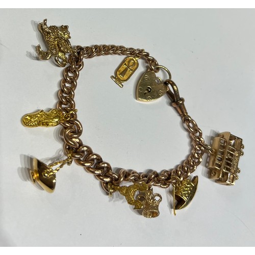 394 - A 9 carat gold bracelet with eight charms of 9, 14 and 18 carat. Total weight 47gm.