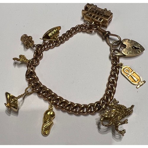 394 - A 9 carat gold bracelet with eight charms of 9, 14 and 18 carat. Total weight 47gm.