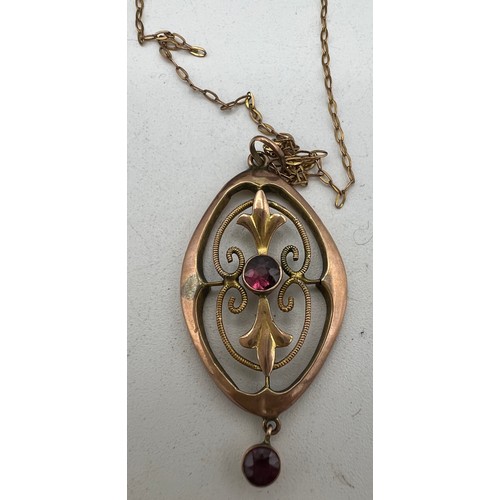 397 - An Edwardian 9 carat gold pendant on fine gold chain set with garnets. Total weight 1.6gm together w... 