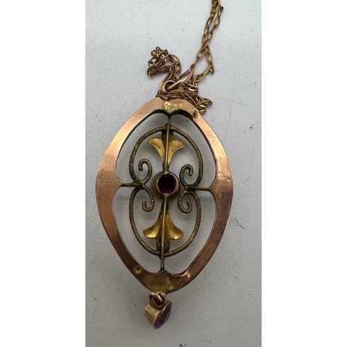 397 - An Edwardian 9 carat gold pendant on fine gold chain set with garnets. Total weight 1.6gm together w... 