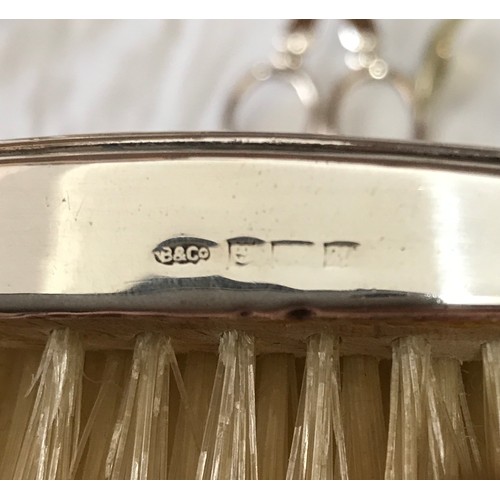 768 - A silver backed brush hallmarked Birmingham 1961 W I Broadway & Co silver weight 22gms along with a ... 