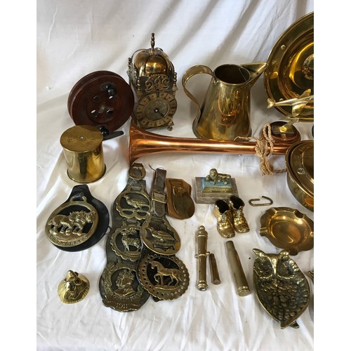 1002 - A large quantity of mainly brass items comprising: pair of candlesticks, companion set, horse brasse... 