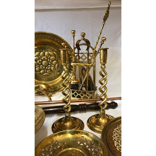 1002 - A large quantity of mainly brass items comprising: pair of candlesticks, companion set, horse brasse... 